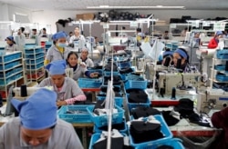 រូបឯកសារ៖ កម្មករ​កំពុង​ដេរ​ស្បែក​ជើង​ក្នុង​រោងចក្រ​ស្បែក​ជើង​មួយ​របស់​ក្រុមហ៊ុន​តៃវ៉ាន់​ ក្នុង​ខេត្ត​កំពង់ស្ពឺ ថ្ងៃ​ទី៤ ខែកក្កដា ឆ្នាំ​២០១៨។