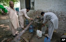 People collect water at a tube well in Islamabad, Pakistan, Aug. 23, 2017. A new study suggests about 50 million Pakistanis could be at risk of drinking arsenic-tainted groundwater.
