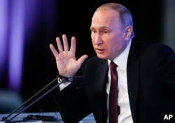 FILE - Russian President Vladimir Putin gestures during his annual news conference in Moscow, Dec. 23, 2016.