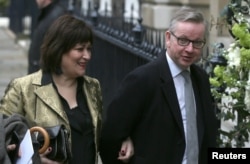 FILE - Michael Gove and wife Sarah Vine arrive for a reception to celebrate the wedding between media mogul Rupert Murdoch and former supermodel Jerry Hall, in London, March 5, 2016.