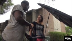 A mechanic named Jerry has been helping his neighbors clean out their flooded vehicles in hopes that he can get them to start, but he said many of them will be a total loss if the water damage is extensive. (G. Flakus/VOA)