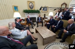 From Left, former Treasury Secretary Henry Paulson; IBM Chairman, President and CEO Ginni Rometty; Ohio Gov. John Kasich; former New York City Mayor Michael Bloomberg, President Barack Obama, Louisiana Gov. John Bel Edwards, Atlanta Mayor Kasim Reed, and former NATO Supreme Allied Commander James Stavridis meet in the Oval Office of the White House in Washington, Sept. 16, 2016.