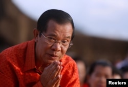 FILE - Cambodia's Prime Minister Hun Sen attends a ceremony at the Angkor Wat temple to pray for peace and stability in Cambodia, Dec. 3, 2017.