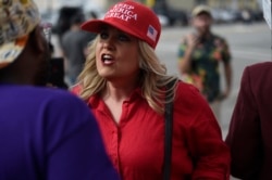A supporter of President Donald Trump clashes with a protester outside the president's appearance at a criminal justice forum on Friday, Oct. 25, 2019, in Columbia, S.C.