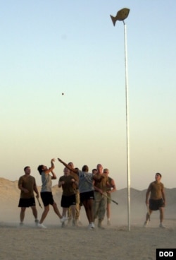 Soldiers from the 120th Engineer Combat Battalion, headquartered in Okmulgee, Oklahoma, play stickball, 2004. Camp Taqaddum, Iraq, Sept. 17, 2004. Courtesy, US Defense Dept., NARA Identifier: 6656317