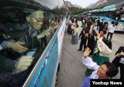 제20차 이산가족 상봉행사 2회차 마지막인 2015년 10월26일 금강산호텔에서 작별상봉을 마친 북측 구송옥(71)씨가 남측에서 온 아버지 구상연(98) 할아버지에게 손을 흔들며 인사하고 있다.