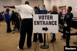 FILE - Voters wait in line to cast their ballots during early voting at the Franklin County Board of Elections in Columbus, in Columbus, Ohio.