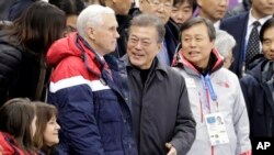 U.S. Vice President Mike Pence, center left, and South Korean President Moon Jae-in attend the women's 500 meters short-track speedskating in the Gangneung Ice Arena at the 2018 Winter Olympics in Gangneung, South Korea, Feb. 10, 2018. U.S. second lady Karen Pence is seen bottom left.