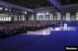 Russian lawmakers, regional governors and other high-ranking officials listen to an address by President Vladimir Putin, in Moscow, Russia, March 1, 2018.
