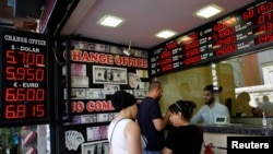 People change money at a currency exchange office in Istanbul, Turkey, Aug. 10, 2018.
