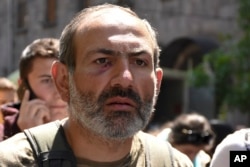 FILE - Opposition leader Nikol Pashinian marches with the other demonstrators to protest the former president's shift into the prime minister's seat in Yerevan, Armenia, April 17, 2018.