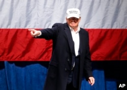 Republican presidential candidate Donald Trump points to the audience at a campaign rally in Sterling Heights, Mich., Sunday, Nov. 6, 2016.