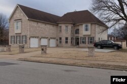 Today's eclectic oversized houses, built in traditional styles, seen here in St. Louis, Missouri, have been referred to as "McMansions." (Photo by Flickr user Paul Sableman via Creative Commons.)