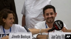 FILE - Jineth Bedoya, left, and Juan Carlos Villamizar, victims of the Colombian armed conflict, smile during a press conference in Havana, Cuba, Nov. 2, 2014.