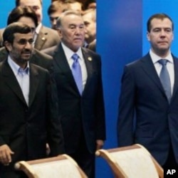 Front row from left, Iranian President Ahmadinejad, Kazakhstan's President Nazarbayev and Russian President Medvedev walk after a meeting of the Shanghai Cooperation Organization in Kazakhstan's capital Astana, June 15, 2011