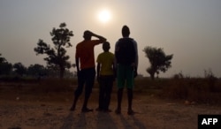 FILE - Three children living in the camp for Internally displaced people (IDP) of Mpoko, and claiming to be victims or witnesses of sexual abuse on minors by peacekeeper soldiers of the French Sangaris operation, posing in Bangui, Feb. 11, 2016.