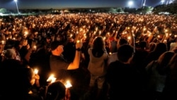 People attend a candlelight vigil the day after a shooting at Marjory Stoneman Douglas High School in Parkland, Florida, U.S., February 15, 2018.
