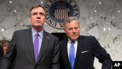 FILE - Senate Intelligence Committee Vice Chairman Mark Warner, D-Va., left, and Sen. Richard Burr, R-N.C., the panel chairman, are pictured prior to a hearing on Capitol Hill in Washington, May 9, 2018.