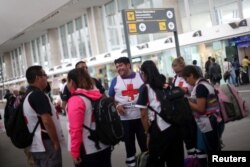 Members of Mexico's Red Cross are pictured before travelling to Houston to provide humanitarian aid at Benito Juarez International airport in Mexico City, Aug. 30, 2017.