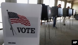 FILE - Voters cast ballots in an Illinois primary in Hinsdale, Ill., March 18, 2014. In past elections, young adults have been on the lower end in terms of voter turnout, and expectations for the coming election appear uncertain.