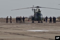 Officers shake hands upon arriving for ceremony marking the construction of an U.S. Aegis Ashore missile defense base in Deveselu, Romania, Monday, October 28, 2013.