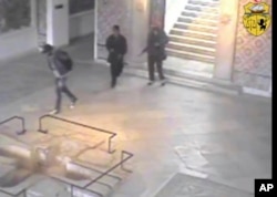 In this frame made from CCTV and released by the Tunisian government, two gunmen and third unidentified man can be seen inside the Bardo museum in Tunis, March 18, 2015.
