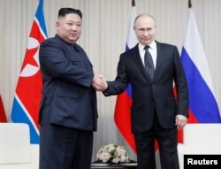 Russian President Vladimir Putin (R) and North Korean leader Kim Jong Un shakes hands during their talks at Far East Federal University on Russky Island in Vladivostok, Russia, Apr. 25, 2019.