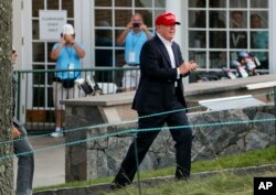 President Donald Trump walks up to his viewing booth on the 15th green at the Trump National Golf Club during the third round of the U.S. Women's Open Golf tournament, July 15, 2017, in Bedminster, New Jersey.