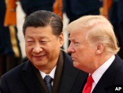FILE - U.S. President Donald Trump and Chinese President Xi Jinping participate in a welcome ceremony at the Great Hall of the People in Beijing, China, Nov. 9, 2017.