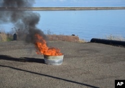 FILE - This Nov. 17, 2016, photo, courtesy of Pacific Northwest National Laboratory, PNNL, shows a controlled oil spill burn at PNNL in Richland, Washington.