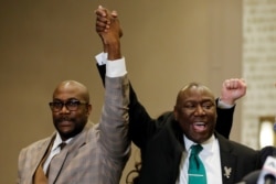 Floyd family attorney Ben Crump and Philonise Floyd raise their fists during a news conference following the verdict in the trial of former Minneapolis police officer Derek Chauvin, found guilty of the death of George Floyd, in Minneapolis, Minnesota