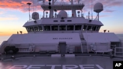 The sun rises over Vulcan Inc.'s research vessel Petrel nearly 200 miles off Midway Atoll in the Northwestern Hawaiian Islands on Friday, Oct. 18, 2019. (AP Photo/Caleb Jones)