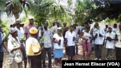 Residents of Beret, Haiti hold seedlings gifted to them by young professionals of Rotaract club.