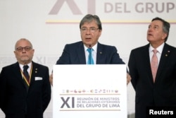 Colombia's Foreign Affairs Minister Carlos Holmes Trujillo reads the final statement after a meeting of the Lima Group in Bogota, Colombia, Feb. 25, 2019.