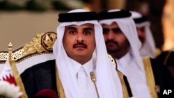 FILE- Qatar's Emir Sheikh Tamim bin Hamad Al-Thani attends a Gulf Cooperation Council summit in Doha, Qatar, Dec. 9, 2014.
