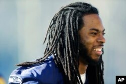 Seattle Seahawks cornerback Richard Sherman walks off the field after football practice, Jan. 24, 2014, in Renton, Washington.