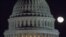 FILE - The moon rises behind the U.S. Capitol Dome in Washington, Dec. 30, 2012.