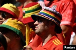 A Wales fan wears a rainbow coloured hat inside the stadium before the match between Wales and Iran on November 25, 2022.