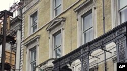 British police officers stand on duty at the Libyan embassy in central London, Mar 30 2011