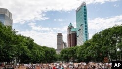 People gather for a memorial service for George Floyd at Cadman Plaza Park in the Brooklyn borough of New York, on June 4, 2020. 