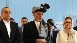 FILE - Afghan President Ashraf Ghani, center, speaks to journalists after voting at Amani high school, near the presidential palace in Kabul, Afghanistan, Sept. 28, 2019.