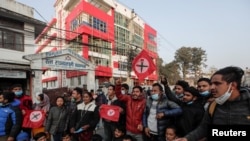People take part in a protest after the parliament was dissolved and general elections were announced to be held in April and May, more than a year ahead of schedule, in Kathmandu, Nepal, Dec. 20, 2020.