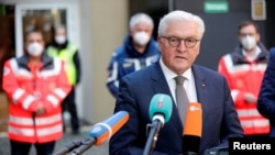 FILE - German President Frank-Walter Steinmeier speaks during a visit at a coronavirus vaccination center in Berlin, Germany, Dec. 21, 2020. 