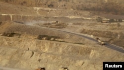 FILE - Trucks are seen at a copper mine in Sarlingyi township March 14, 2013. A number of copper mines in Myanmar were named in the latest list of sanctions issued by the U.S. on July 2, 2021.