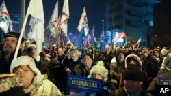 Protesters rally against the government in front of the headquarters of the public broadcaster MTVA in Budapest, Hungary, Dec. 17, 2018. 