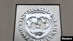 FILE - The International Monetary Fund (IMF) logo is seen at the IMF headquarters building during the 2013 Spring Meeting of the International Monetary Fund and World Bank in Washington.