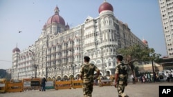 Indian police officers walk outside the Taj Mahal Hotel, one of the sites of the Mumbai terror attacks on its ninth anniversary in Mumbai, India, Nov. 26, 2017. The attack by Pakistani gunmen in India's financial capital on Nov. 26, 2008 killed 166 people.