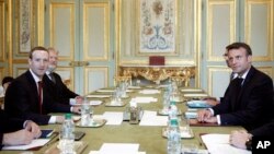 Facebook CEO Mark Zuckerberg (L), and French President Emmanuel Macron meet at at the Elysee Palace, in Paris, May 10, 2019.