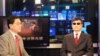 VOA's Huchen Zhang interviews blind Chinese activist Chen Guangcheng for VOA Mandarin's Wei Shi, January 31, 2013. (J. Featherly/VOA) 