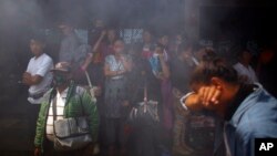 Smoke rises from the cremation pyre of mountaineers, killed in an avalanche on Mount Everest, during a funeral ceremony in Katmandu, Nepal, Monday, April 21, 2014.